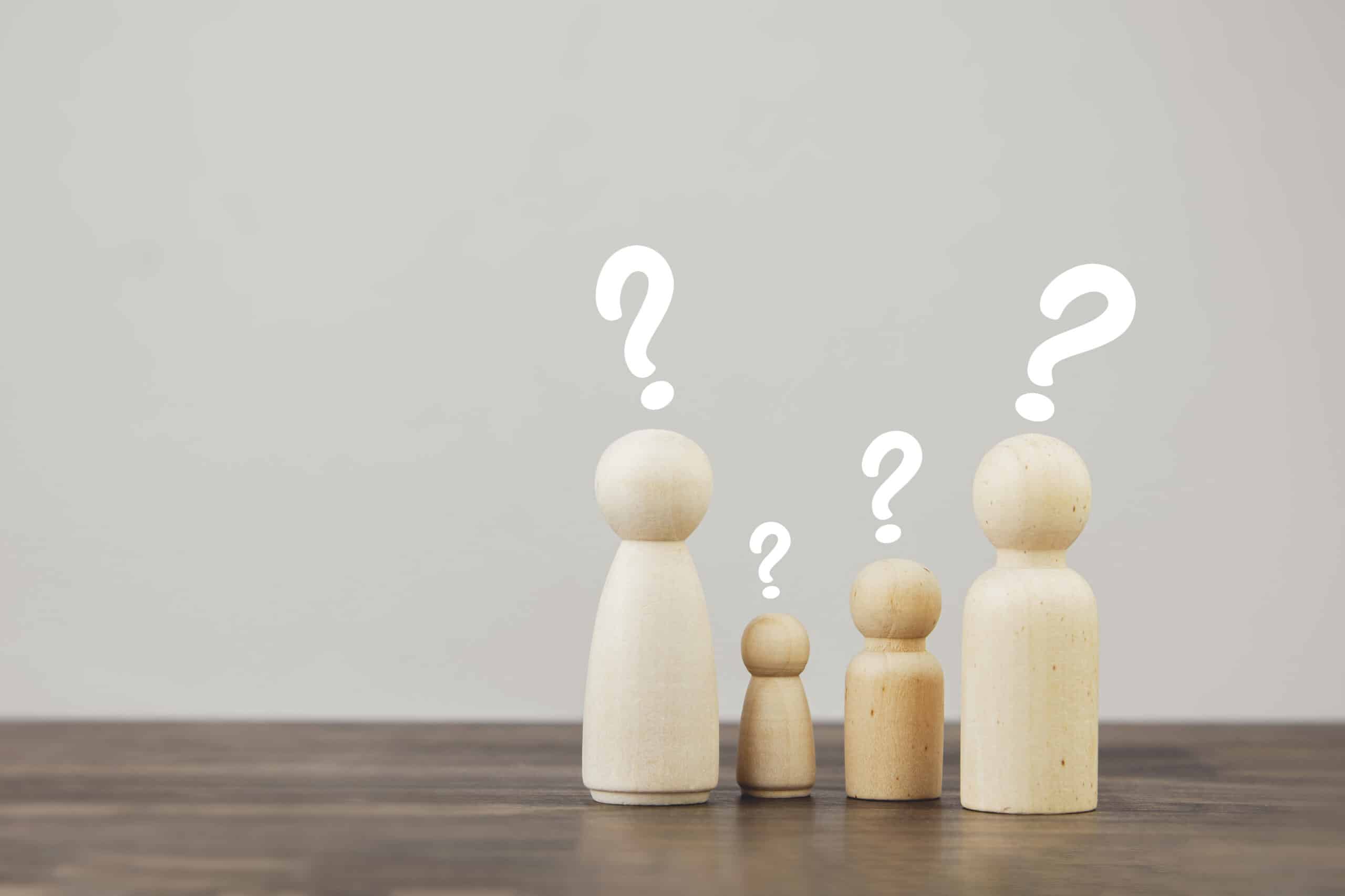 Wooden family figures with question marks symbolizing home loan inquiries.