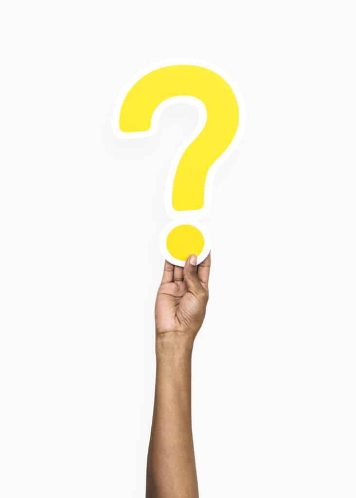 Hand holding a yellow question mark symbol representing loan support inquiries at Apex Finance Brokers.